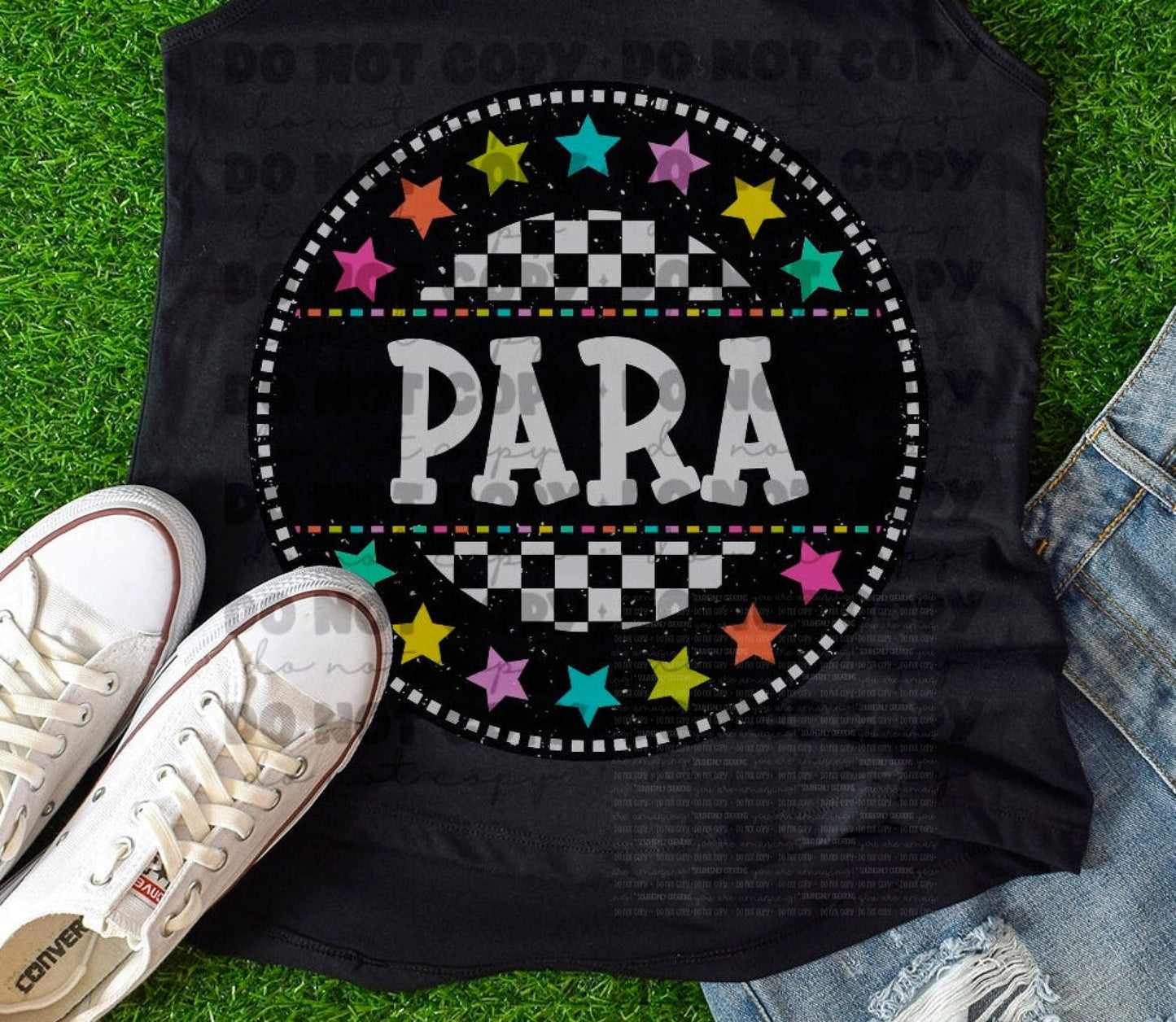 Black tank top with 'PARA' design on grass, accompanied by white sneakers and denim shorts.
