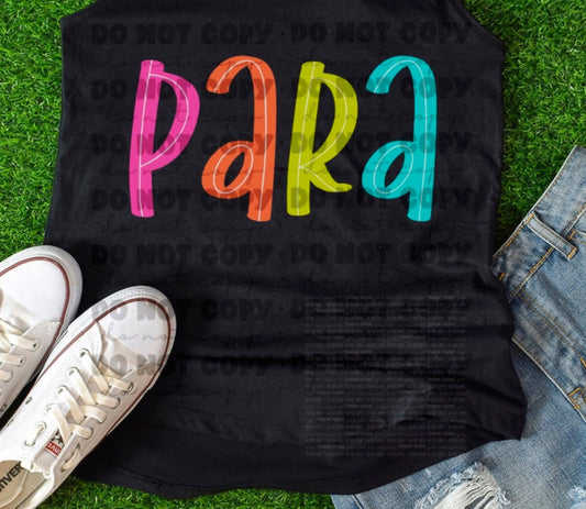 Black tank top with colorful ' PARA' text on grass, paired with white sneakers and denim shorts.